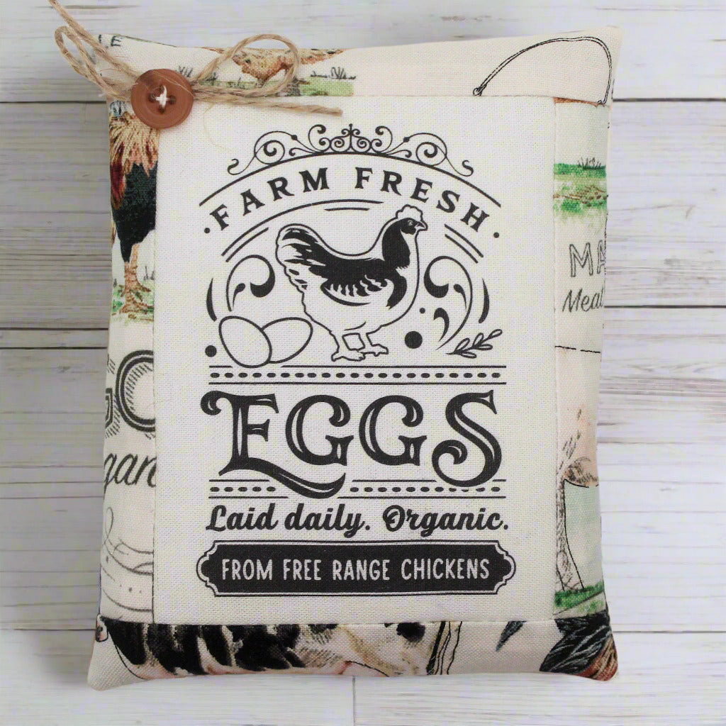 Decorative miniature pillow tuck sign with 'Farm Fresh Eggs' text and chicken illustrations on a wooden background