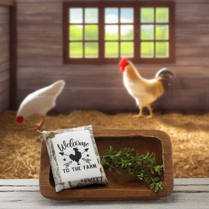 Decorative sign with 'Welcome to the Farm' text in a barn setting with chickens.