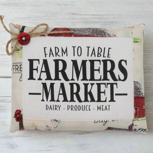 Decorative mini pillow bowl filler sign with 'Farm to Table Farmers Market' text on a wooden background