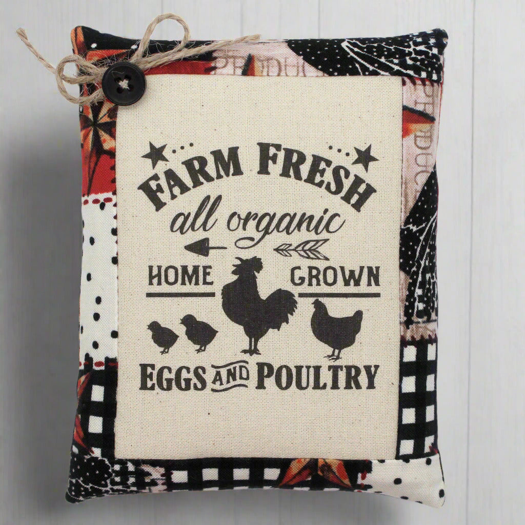 Decorative pillow tuck with 'Farm Fresh' text and chicken illustrations on a patterned background.