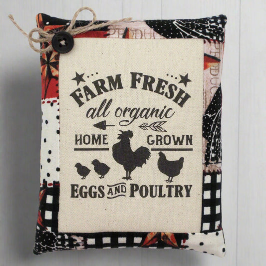 Decorative pillow tuck with 'Farm Fresh' text and chicken illustrations on a patterned background.