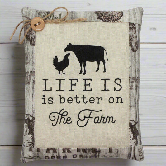 Decorative pillow tuck with farm animals and text on a white background