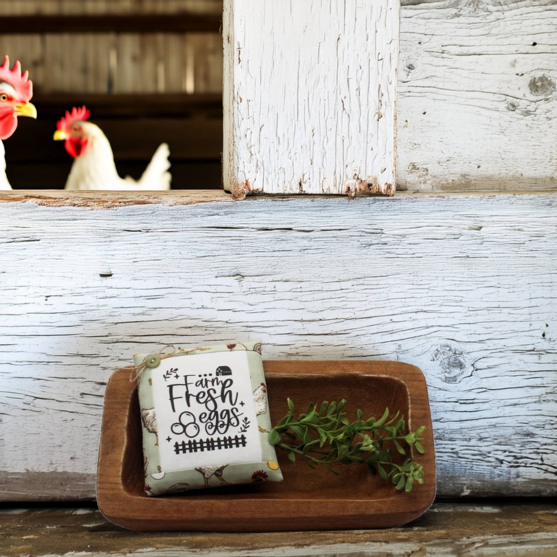 Mini pillow bowl filler sign with 'Farm Fresh Eggs' label on a wooden tray in front of chickens in a coop.