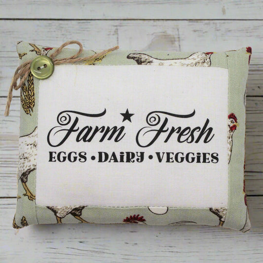 Fabric pillow tuck with 'Farm Fresh' text on a wooden background