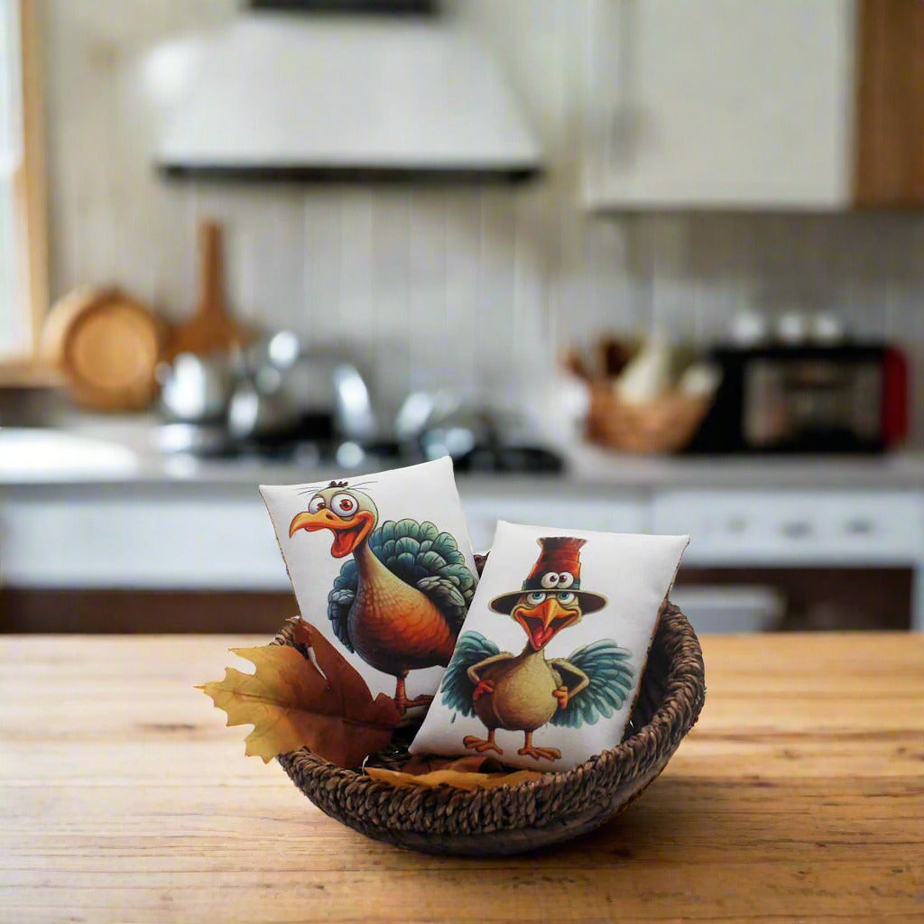 Two decorative mini pillows with cartoon turkeys in a wicker basket 