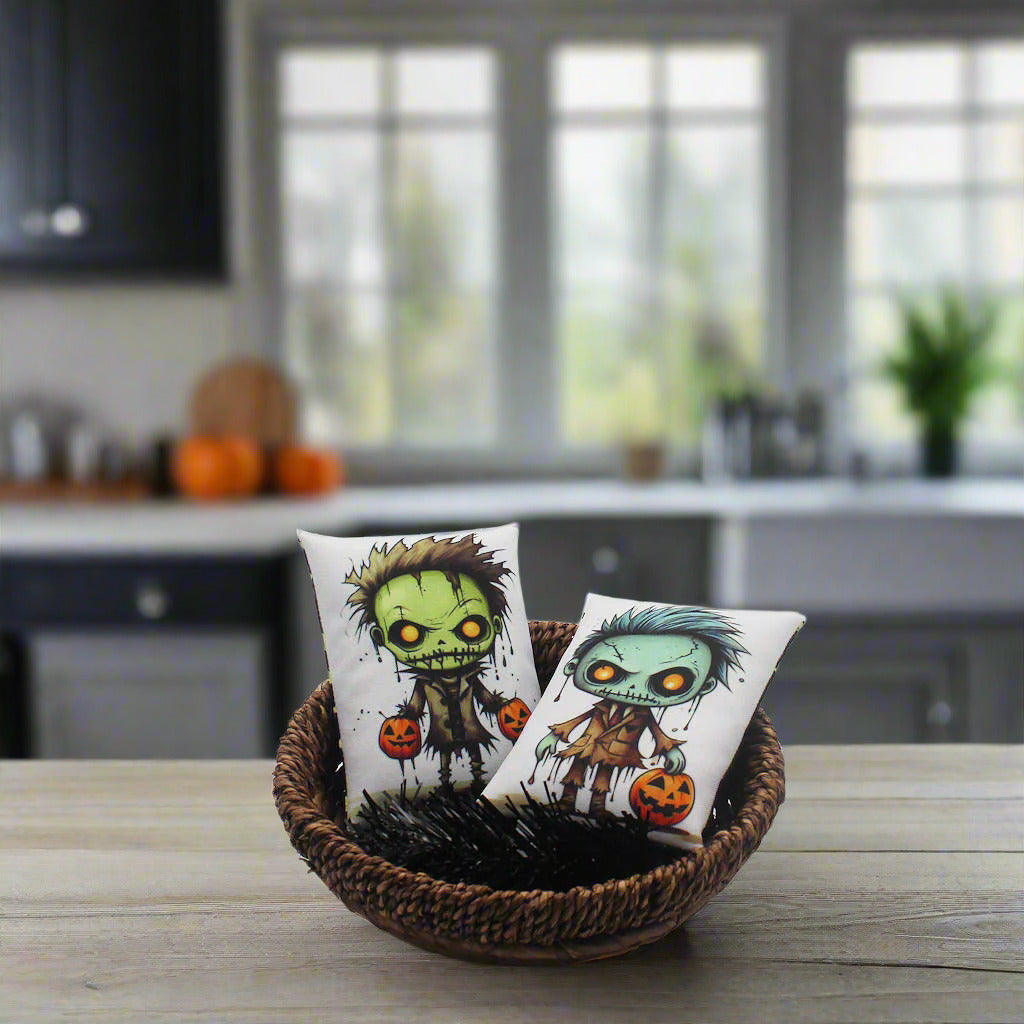 Two small pillows with cartoon zombie designs in a wicker basket