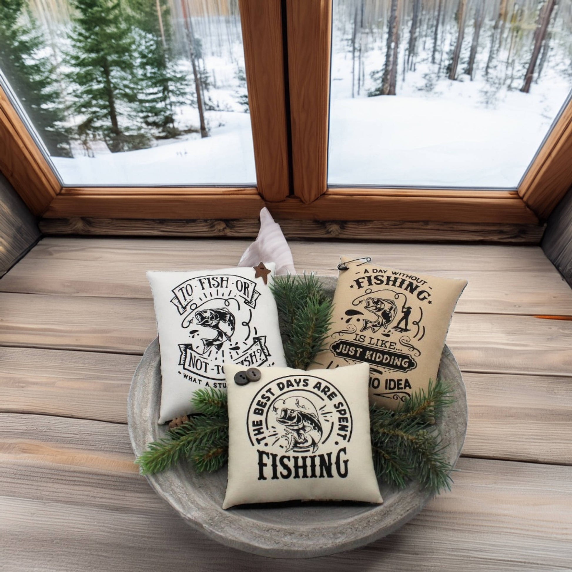 Three fishing-themed pillows in a decorative bowl with a snowy window view.