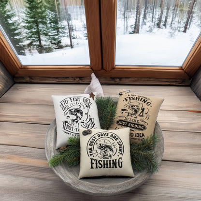 Three fishing-themed pillows in a decorative bowl with a snowy window view.