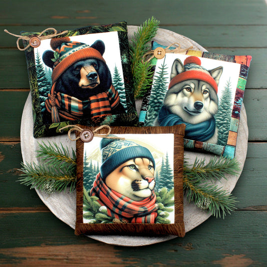 Decorative pillows with animal illustrations wearing hats and scarves on a wooden tray.