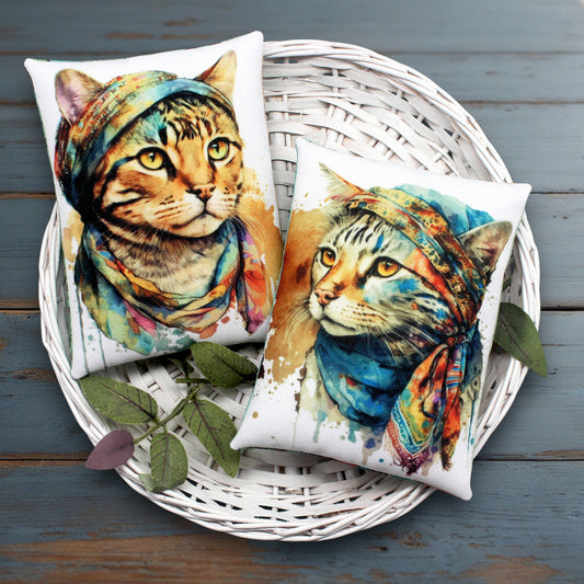 Two decorative pillows with cat designs on a white wicker basket.