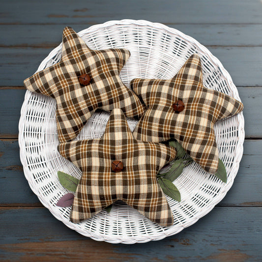 Set of three homespun fabric stars in brown, gold and beige with rusty bells in the centers