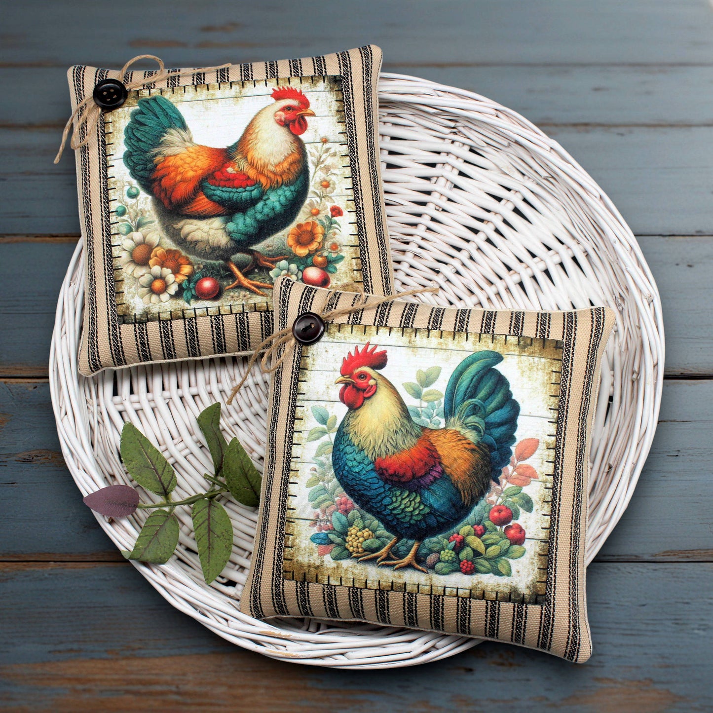 Two decorative chicken and rooster-themed mini pillows on a woven basket with a wooden background.