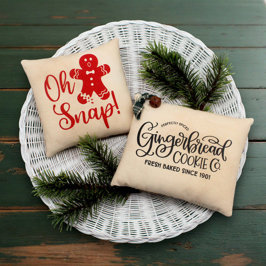 Set of two screen printed mini pillow bowl fillers with gingerbread cookie text and designs