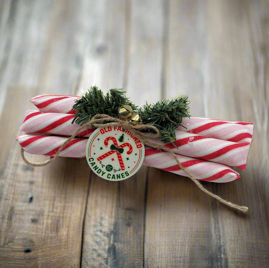 Bunch of candy canes tied with a decorative tag on a wooden surface