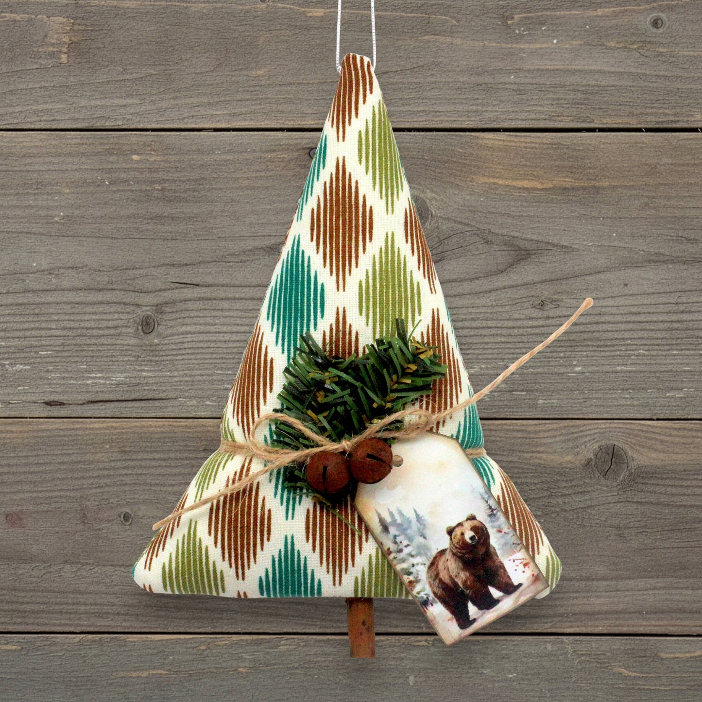Handcrafted rustic tree-shaped holiday ornament with a cardstock tag with a bear