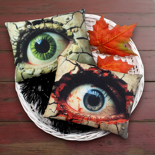 Set of two whimsical bowl filler mini pillows for Halloween decorating featuring a couple of creepy eyes