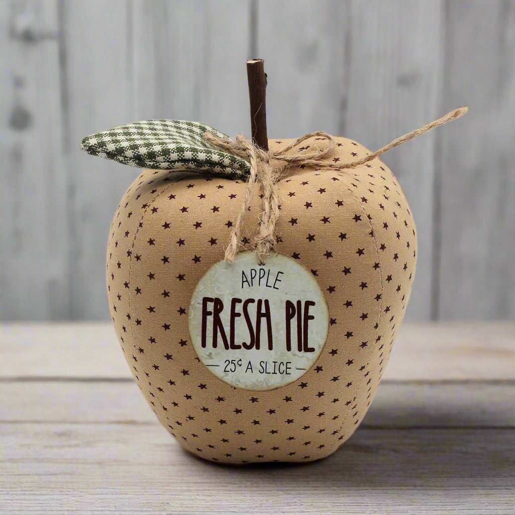 Fabric apple bowl filler with 'Fresh Pie' label on a wooden surface