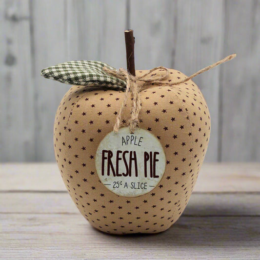 Fabric apple bowl filler with 'Fresh Pie' label on a wooden surface
