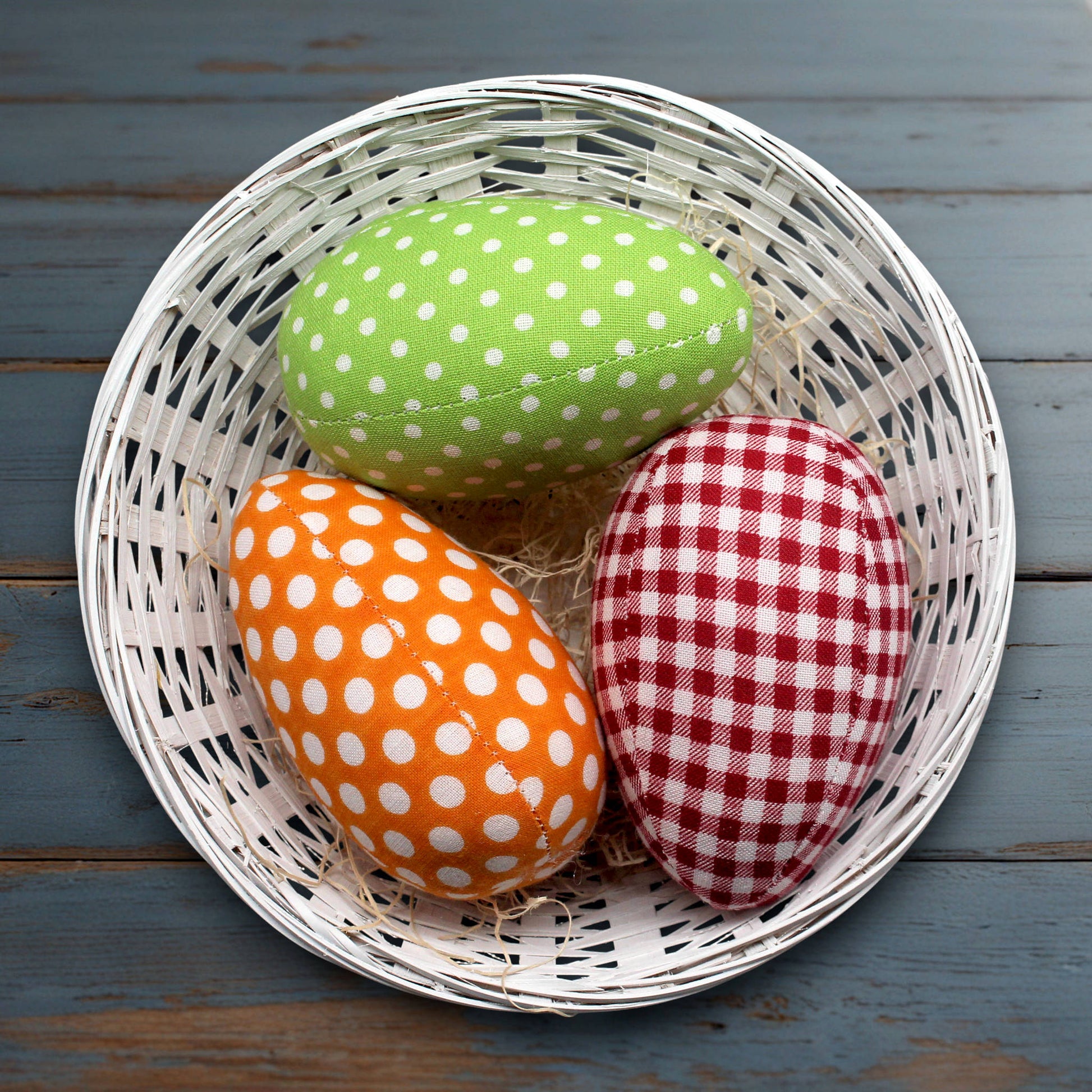 Set of three fabric eggs in a basket