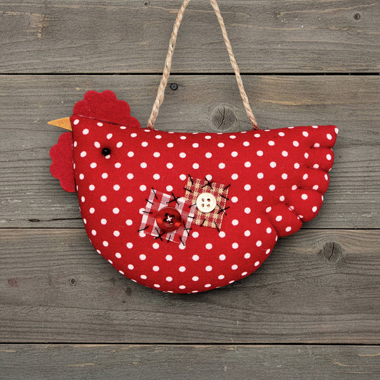 Red polka dot chicken ornament on a wooden background