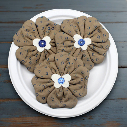 Set of three flower bowl fillers sewn from a cotton print fabric with tiny blue flowers on a light brown background