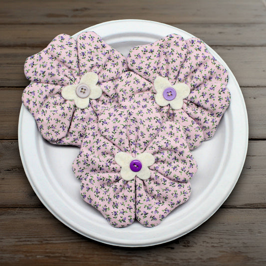 Set of three flower bowl fillers sewn from fabric with tiny purple flowers on a lavender background