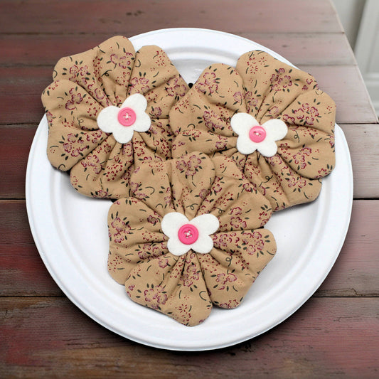 Set of three flower bowl fillers sewn in a tan fabric with a small pink floral design