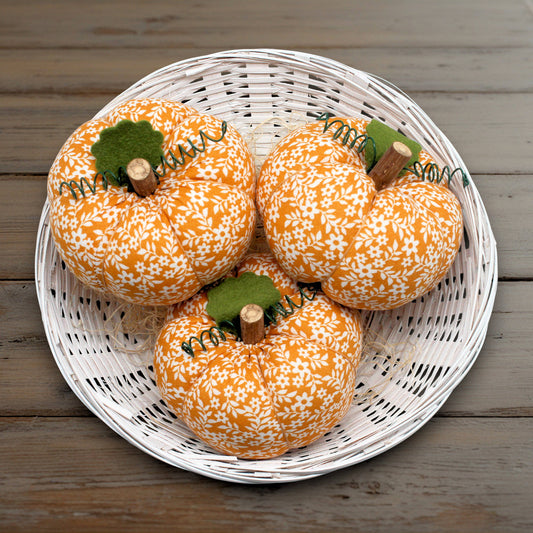 Set of three small fabric pumpkins with an orange and white floral print design
