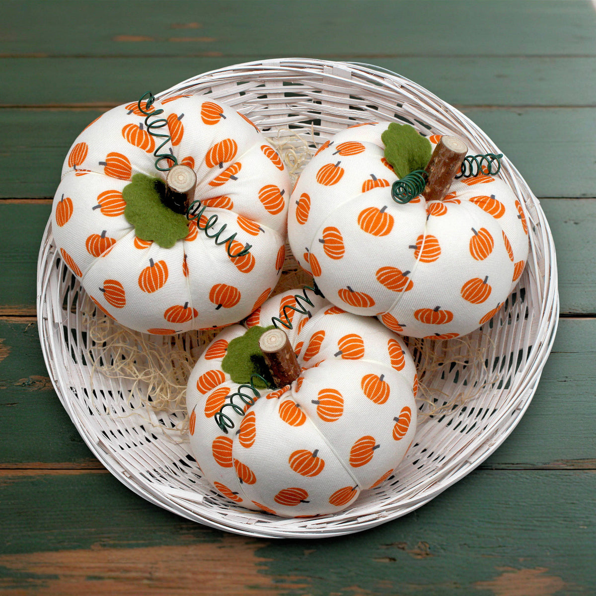 Set of three small fabric pumpkins with green leaves and wire tendrils