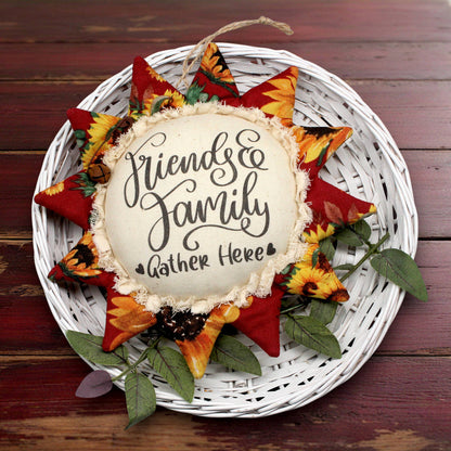 Primitive sunflower ornament with 'Friends & Family Gather Here' text on a white background