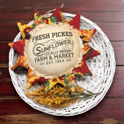 Primitive fabric sunflower ornament with an advertisement for a farm market