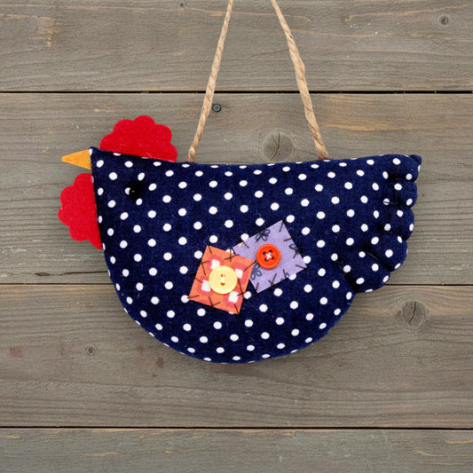 Decorative chicken ornament with polka dot pattern on a wooden background