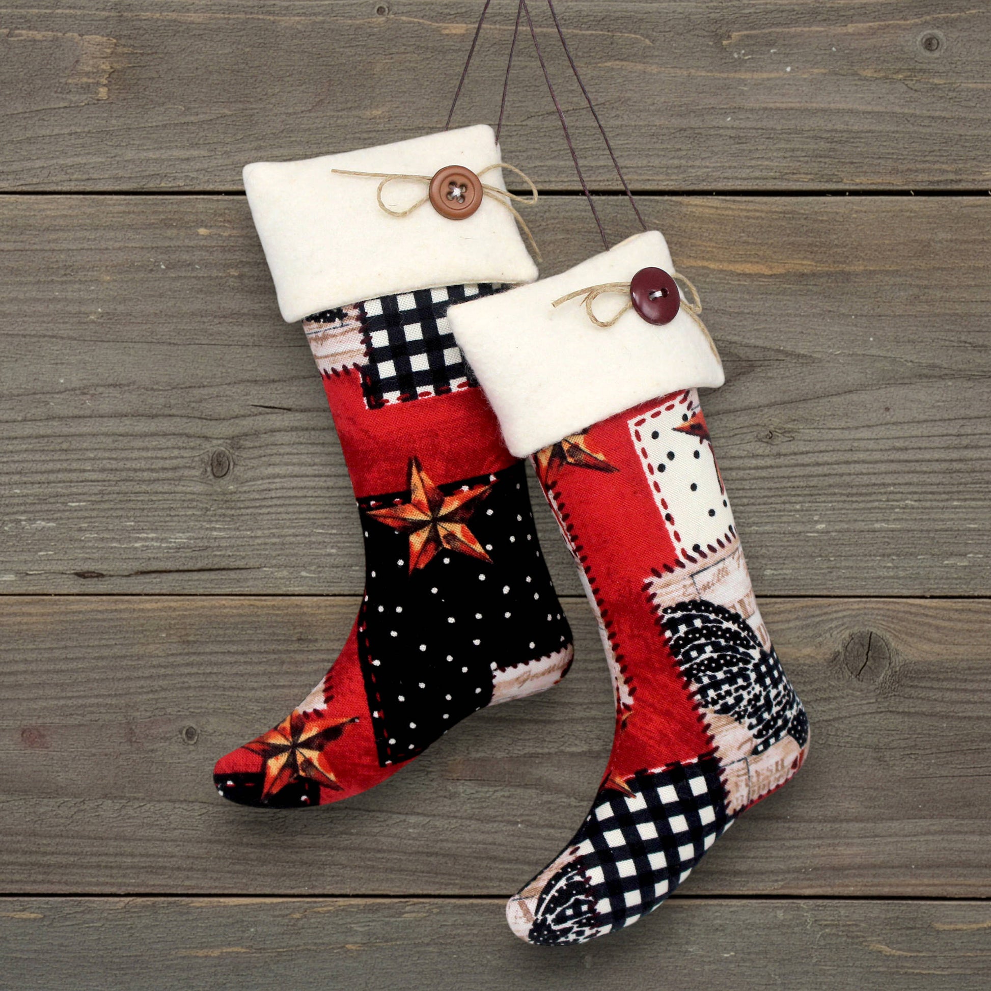 Pair of Christmas stocking ornaments with rusty stars and chickens on a patchwork style background.