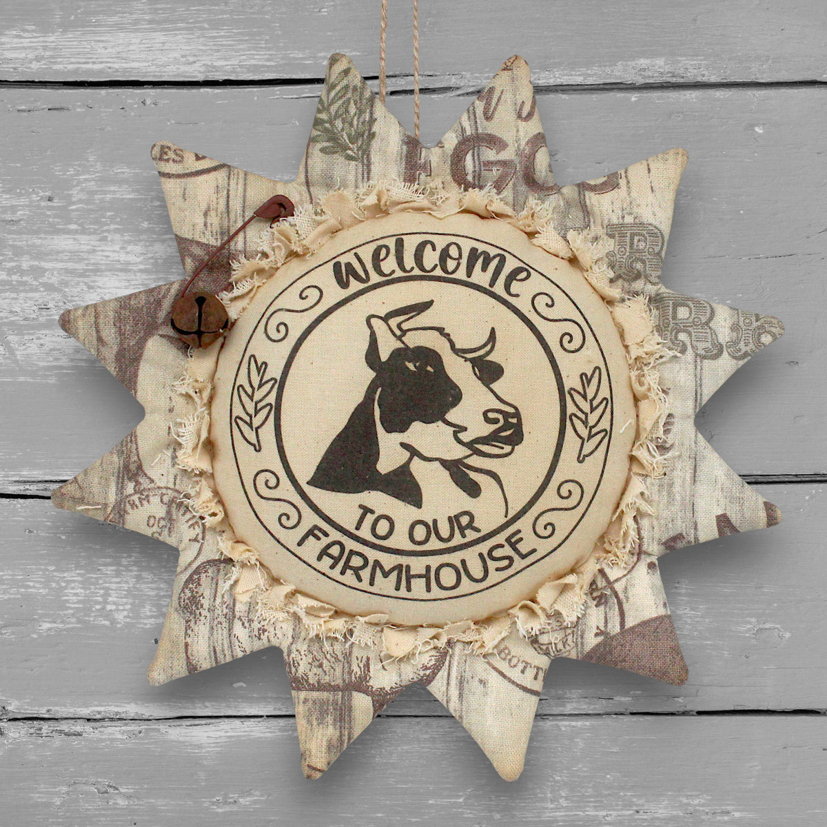 Primitive handmade fabric sunflower ornament or bowl filler with a printed center with an image of a cow and text that reads "welcome to our farmhouse."