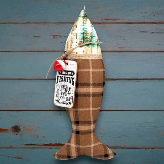 Decorative fish-shaped lantern with plaid pattern and 'Bad Day Fishing' tag on a wooden background