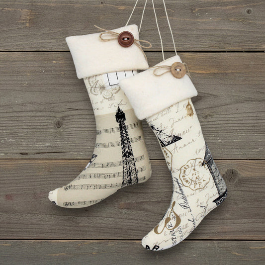 Two decorative stockings with vintage designs on a wooden surface