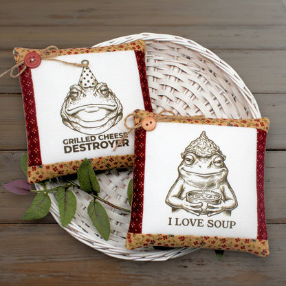 Set of two mini pillow bowl fillers featuring funny frogs or toads who love grilled cheese and soup.