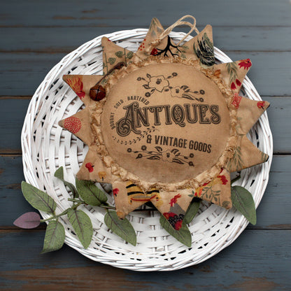 Decorative primitive sunflower ornament with 'Antiques & Vintage Goods' text
