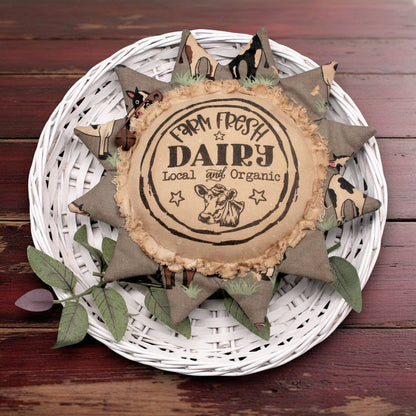 Primitive sunflower ornament with an advertisement for a farm fresh dairy