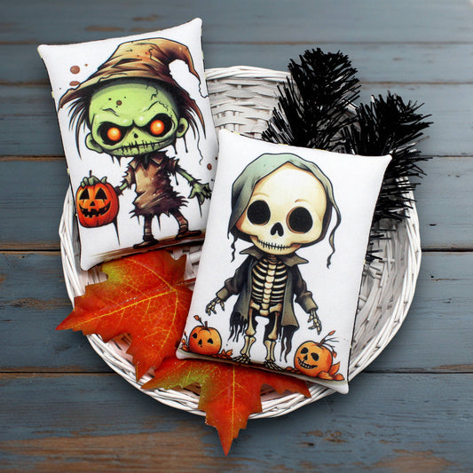 Two Halloween-themed pillows with cartoon characters on a wooden surface.