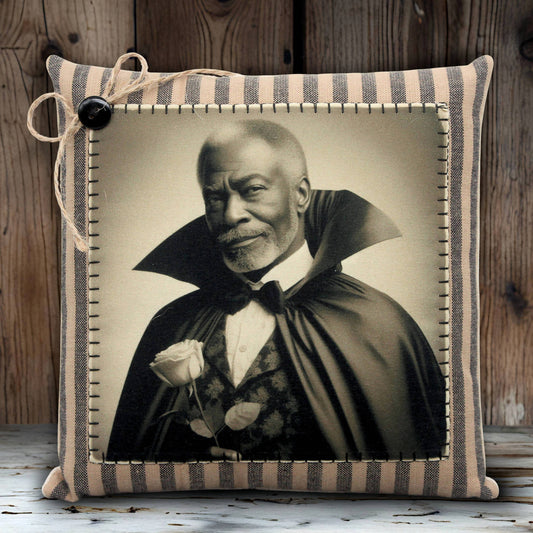 Pillow with a vintage-style portrait of a handsome vampire in a cape holding a rose, against a wooden background.