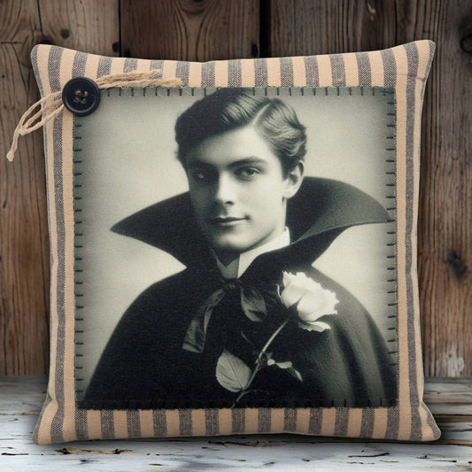 Decorative pillow with a vintage-style portrait of a handsome young vampire in a dark cape on a white background