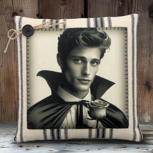 Decorative pillow with a black and white portrait of a handsome young vampire holding a rose on a striped background.