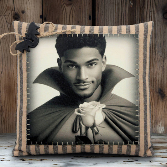 Decorative pillow with a black and white portrait of a handsome young vampire holding a rose, framed by a striped border.