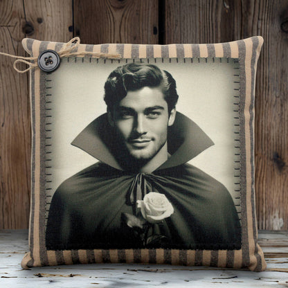 Pillow with a black and white portrait of a handsome young vampire in a cape holding a rose, framed by a striped border.