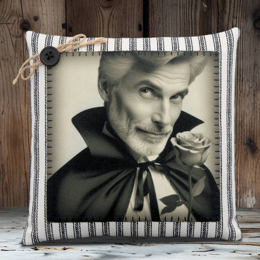 Pillow with a black and white portrait of a handsome vampire holding a rose, framed by a striped border.