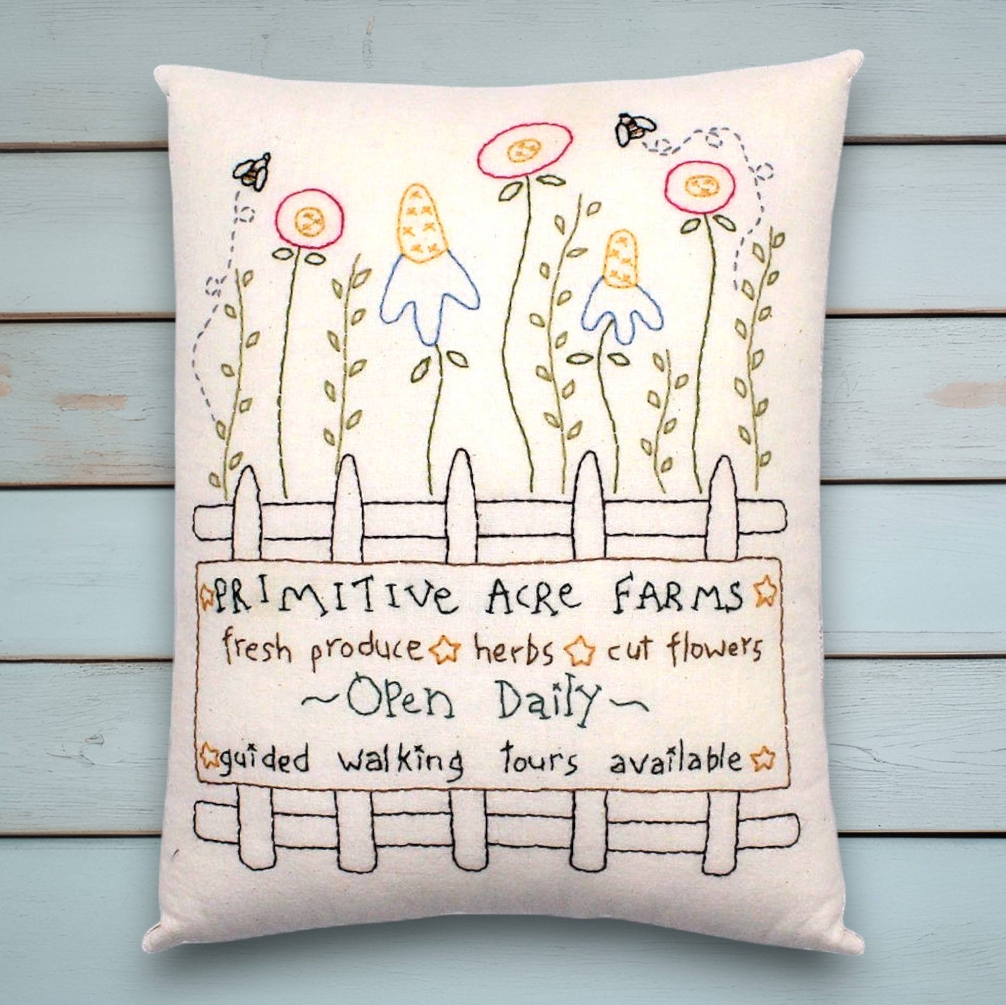 Decorative hand-stitched pillow with a primitive garden design