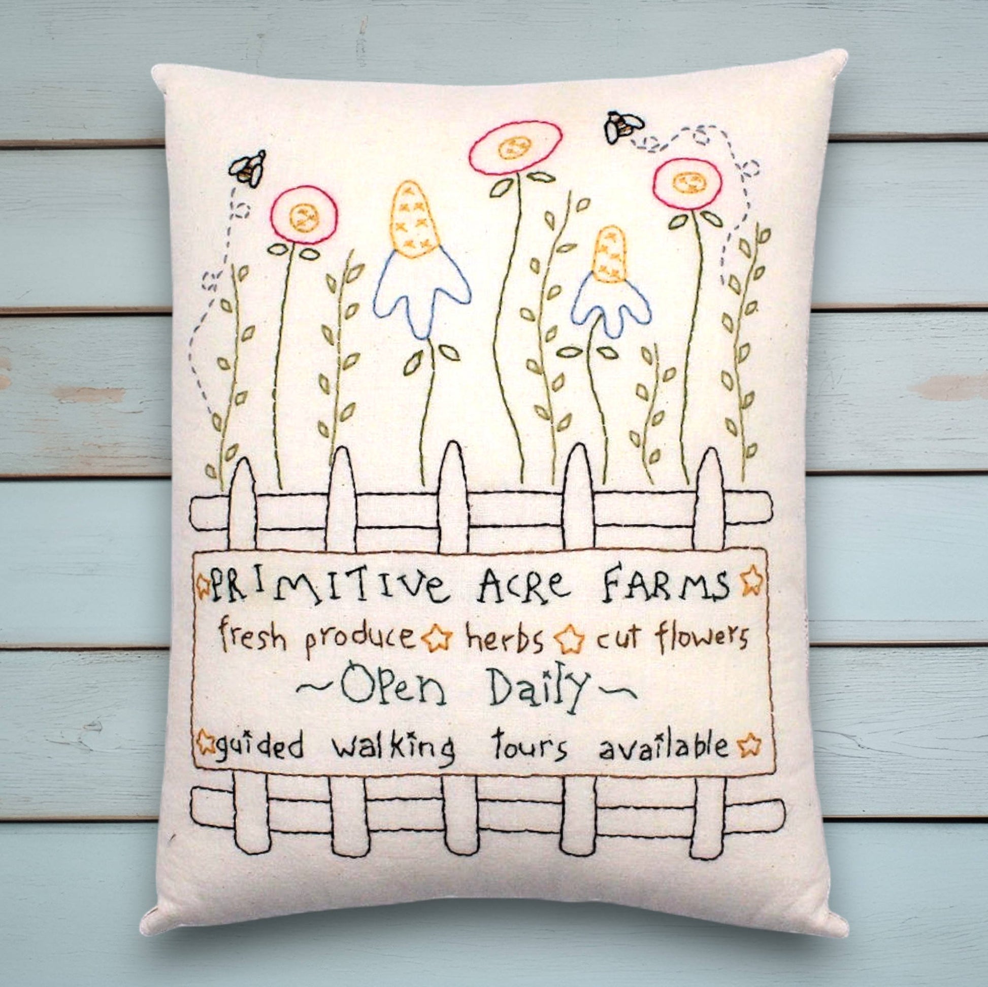Decorative hand-stitched pillow with a primitive garden design