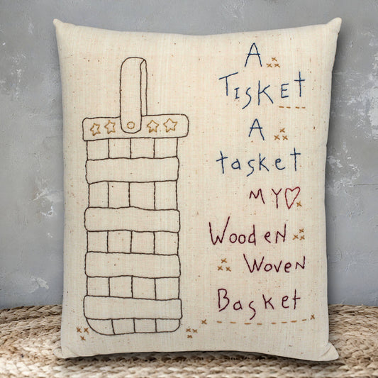 Decorative pillow with a woven basket design and text on a textured surface.