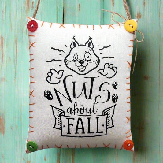Fabric mini pillow sign with a squirrel design and 'Nuts about Fall' text